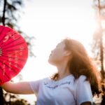 Person cooling off with a fan during a summer power outage