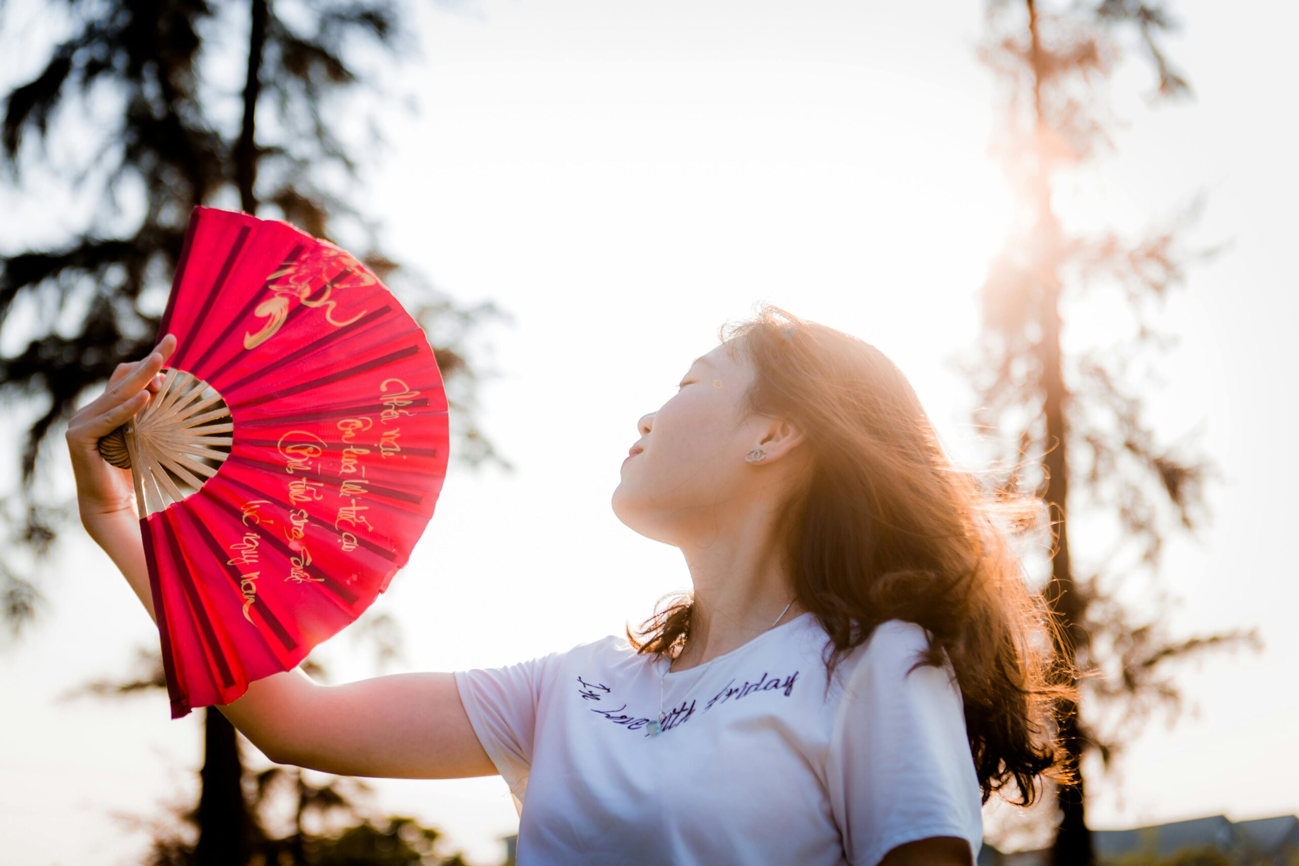 Person cooling off with a fan during a summer power outage